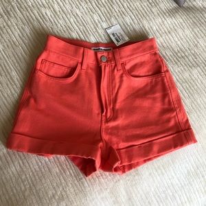 Coral colored jean shorts